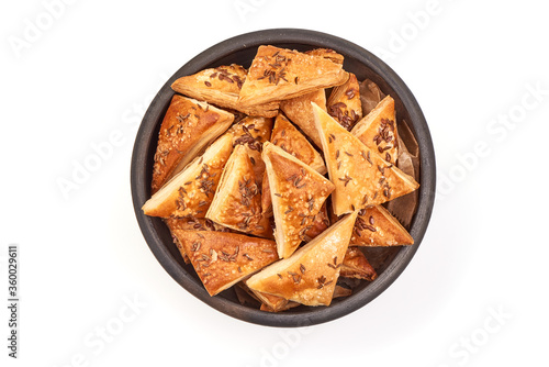 Puff pastry pies coated with flaxseeds, isolated on white background photo