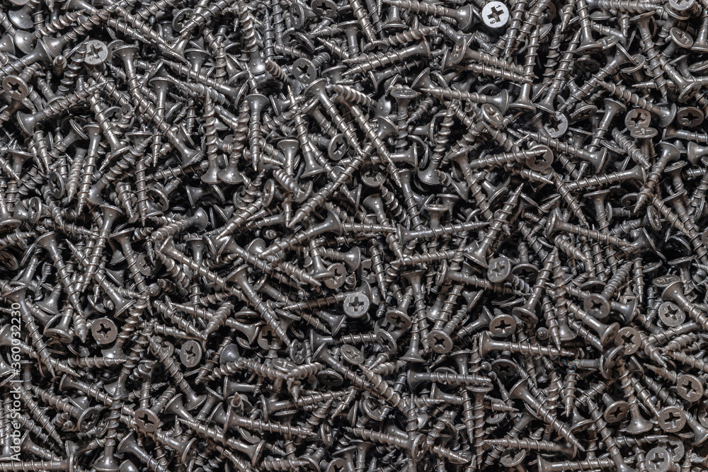 Wood screws. Texture. Background for wallpaper. A lot of black screws. View from above. Wood screws. Texture. Background for wallpaper. A lot of black screws. View from above.