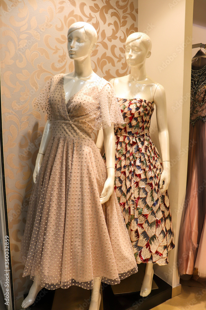 Women's fashion and style. original women's evening dress. women's accessories. female mannequin in a shop Women's fashion and style. original women's evening dress. women's accessories. female mannequin in a shop