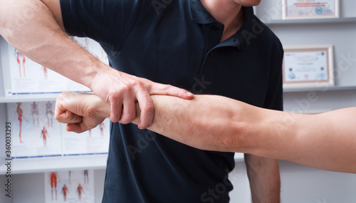 Obraz na plátně Physical therapist  checking an arm in his cabinet