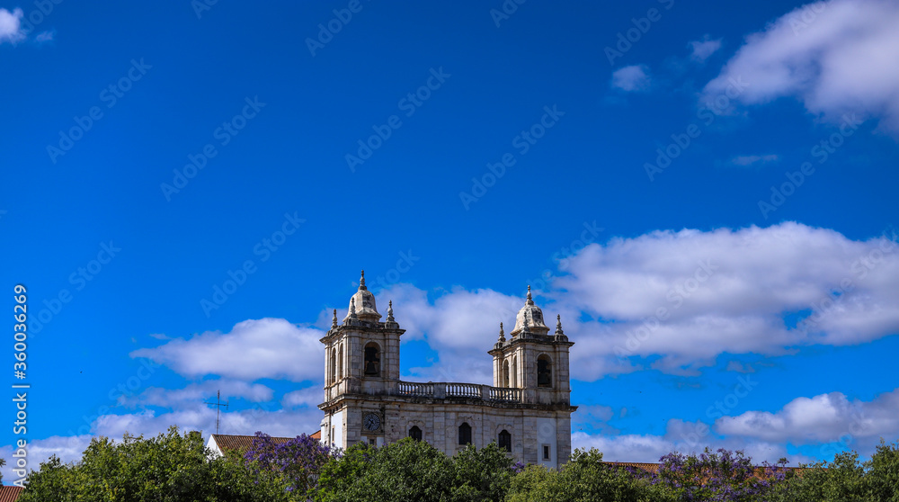 Wonderful sacred and religious architecture formed by church and statues with birds flying in the center of the Portuguese city of Estremoz in the interior of the Alentejo.