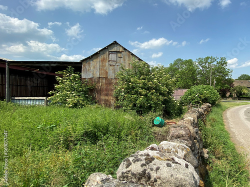 Old farm building, next to a dry stone wall in, Stirton with Thorlby, Skipton, Yorkshire photo