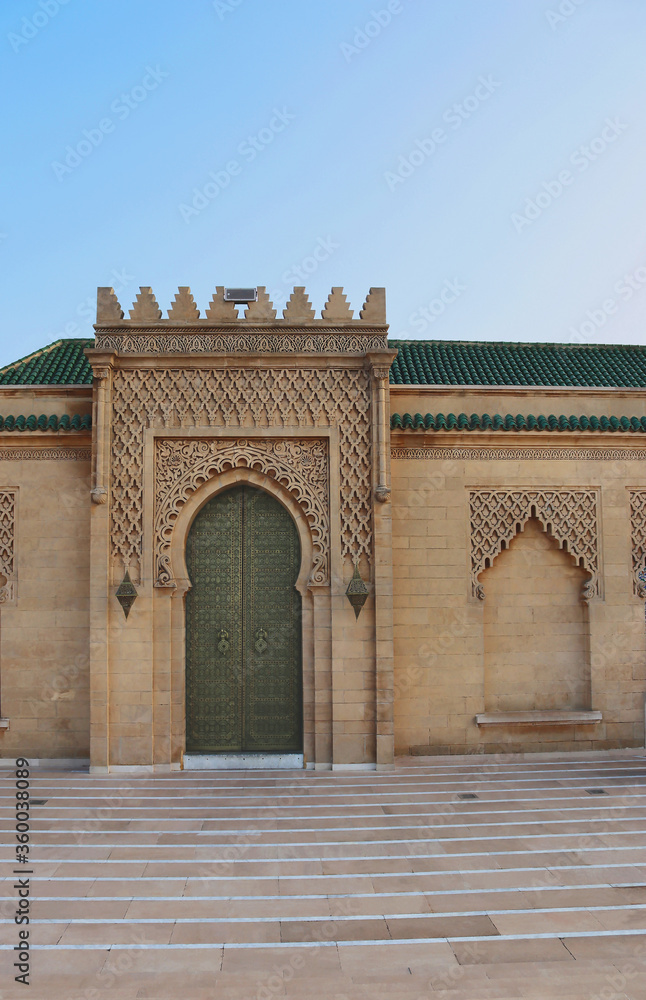 Traditional door decorated in a detailed Moroccan and Islamic design. Photo taken at the Hassan tower and mosque in Rabat, Morocco.