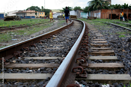 santo amaro, bahia / brazil - may 13 2017: people are seen walking near a train track in the city of Santo Amaro photo