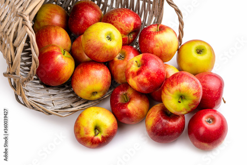 Red-yellow apples and a basket. Isolate on white background