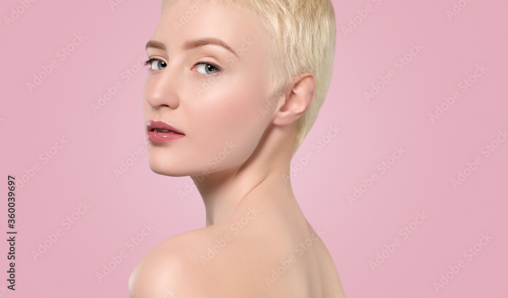 Portrait of a beautiful woman with short blonde hair, beautiful fresh make-up and with healthy clean skin on a pink background. Make-up and cosmetology concept. Portrait of a beautiful woman with short blonde hair, beautiful fresh make-up and with healthy clean skin on a pink background. Make-up and cosmetology concept.