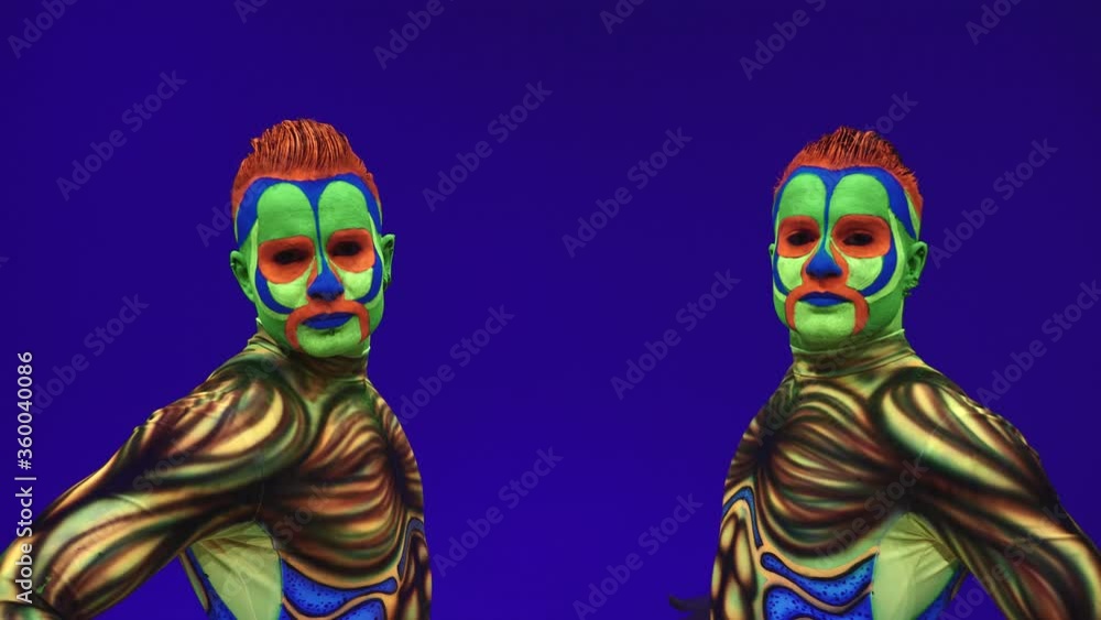 Acrobatic twins in neon costumes to perform a stand on the hands and ...