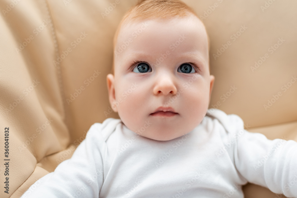 top view of adorable infant boy lying and looking away