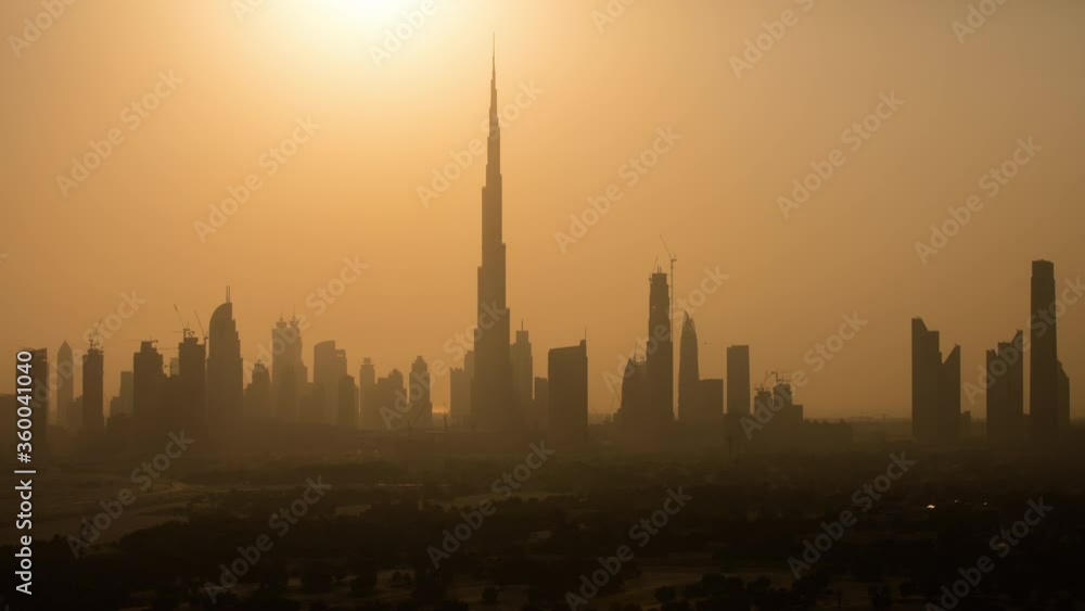 Timelapse of Dubai skyline from Day to Night. Silhouette of the skyline with Burj Khalifa transforming to a view of lights of the beautiful city of Dubai Uae Timelapse of Dubai skyline from Day to Night. Silhouette of the skyline with Burj Khalifa transforming to a view of lights of the beautiful city of Dubai Uae