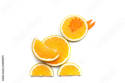 Food art creative concepts. Cute duck made of fruits and vegetables, such as orange, mango and carrots isolated on a white backgroun