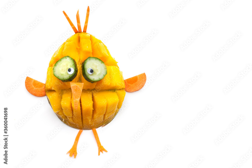 Obraz premium Food art creative concepts. Funny bird made of fruits and vegetables, such as orange, mango and carrots isolated on a white background