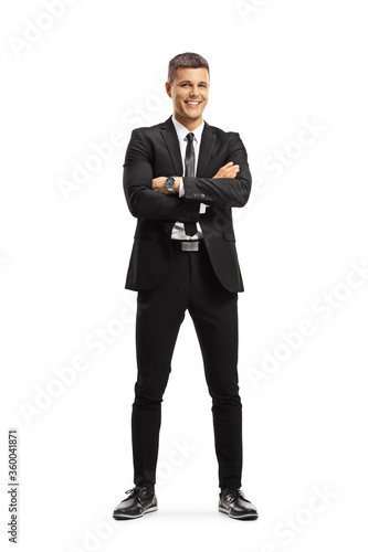 Young professional man in a suit posing with crossed arms