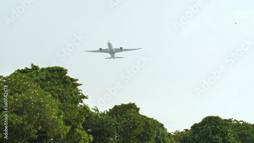Take-off aircraft on the background of the jungle and trees in Indonesia.