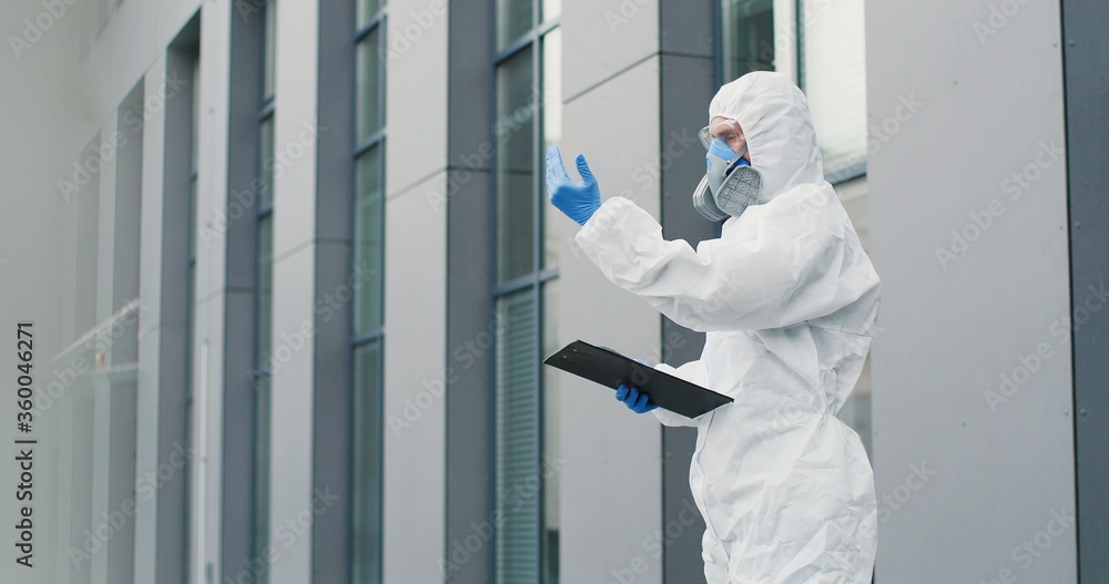 custom made wallpaper toronto digitalFemale office worker in mask going to work and man in white suit and respirator measuring her temperature, letting go. Allowing pass to business center for visitor. Covid-19 pandemic. Permit to enter.