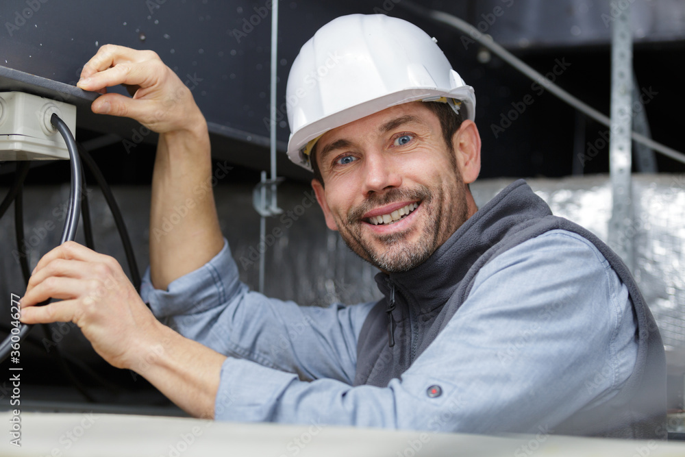 handsome joyful electrician in hardhat handsome joyful electrician in hardhat