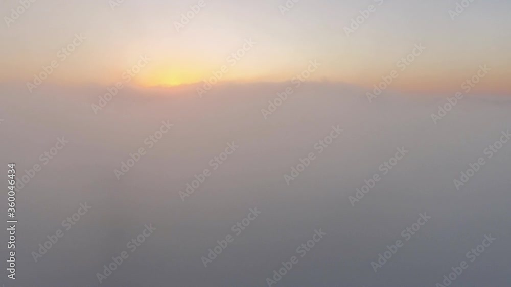 Flying above the clouds - View from a airplane at sunset / sunrise in 4k Flying above the clouds - View from a airplane at sunset / sunrise in 4k