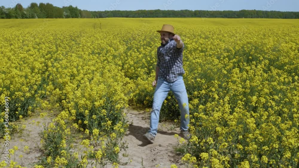 Happy Man Farmer Dancing Enjoying at Rape Blossom On Field. Fun Celebrating Funny Viral Dance Freedom. Guy Enjoying Dance. Joyful Man Farmer Dancing. Slow Motion. Flowering Rapeseed Field Blue Sky. Happy Man Farmer Dancing Enjoying at Rape Blossom On Field. Fun Celebrating Funny Viral Dance Freedom. Guy Enjoying Dance. Joyful Man Farmer Dancing. Slow Motion. Flowering Rapeseed Field Blue Sky.
