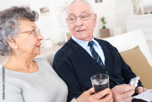 old couple taking a medication at home