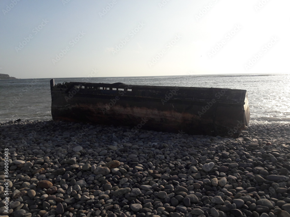 Abandoned row boat on a beach in Lima Peru