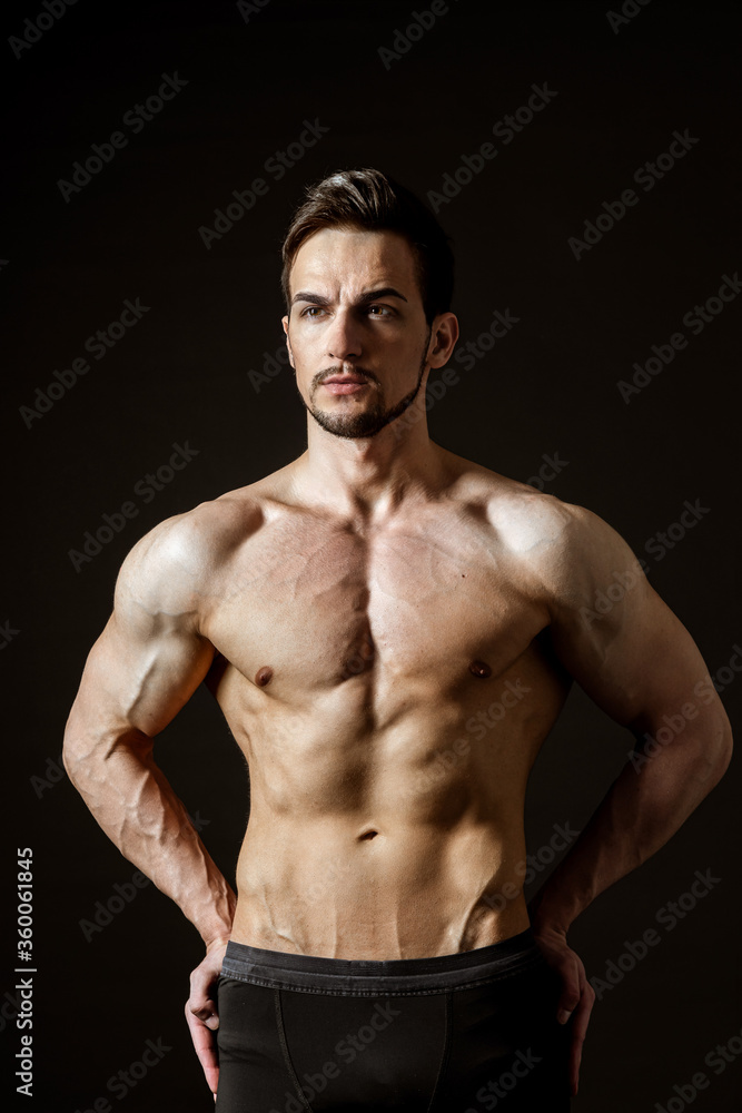 Portrait of an attractive muscular man on a dark background
