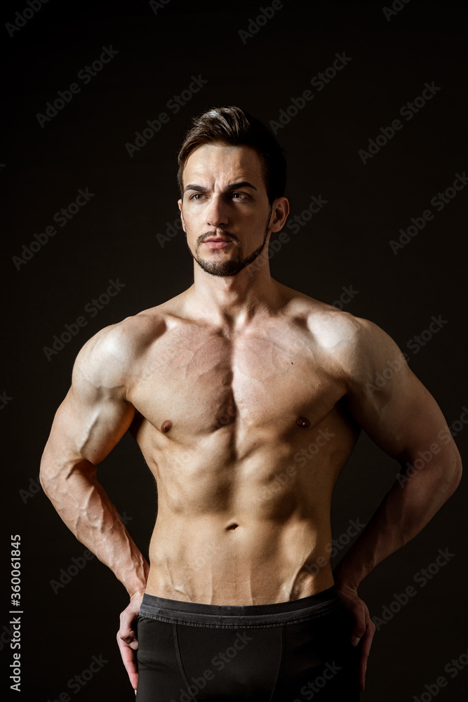 Portrait of an attractive muscular man on a dark background Portrait of an attractive muscular man on a dark background