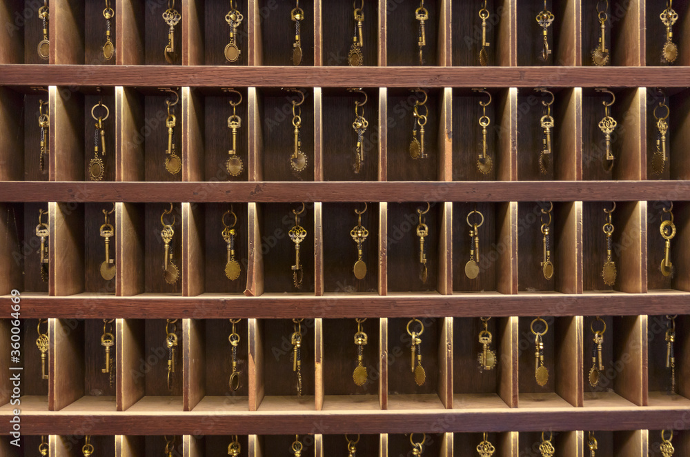 Retro keys in wooden storage, hotel reception, old vintage style, all keys  in a place Photos | Adobe Stock