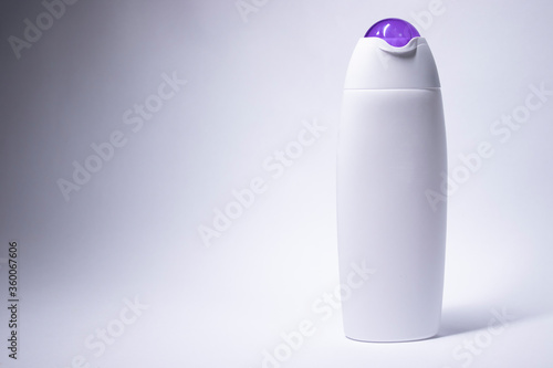 white shampoo bottle with purple neck and no label. body care and beauty concept. Copy space. High quality photo