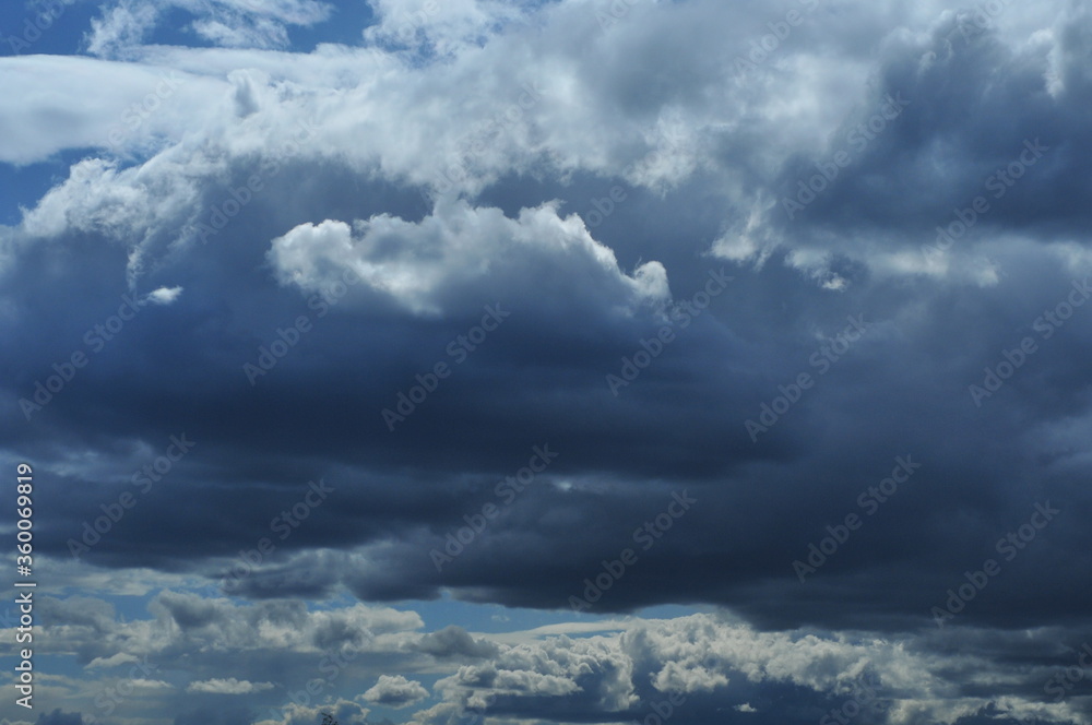 Fototapeta premium Close up of blue sky with a light and dark clouds.