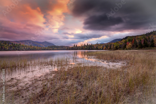 Scenic landscape with orange and black skies in Autumn at Connery Pond  Adirondacks  New York State.