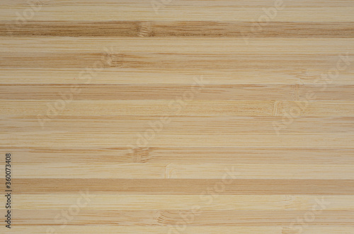 Texture of the surface assembled from bamboo planks. Background of a wooden cutting Board.