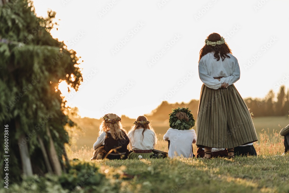 Fototapeta premium Folk people watching summer solstice sunset (Ligo) in Latvia