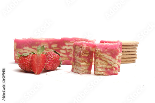 Selective focus of strawberry "batik" cake with the ingredient insight. It is frozen cake made with egg, butter, biscuits, milk and strawberry flavour. 