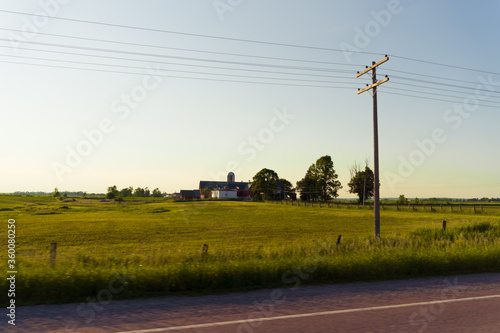 Car window view of a farm in northern Canada from a moving vehicle