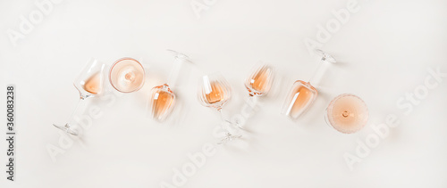 Rose wine variety layout. Flat-lay of rose wine in various glasses over plain white background, top view. Summer drink for party, wine shop or wine tasting concept