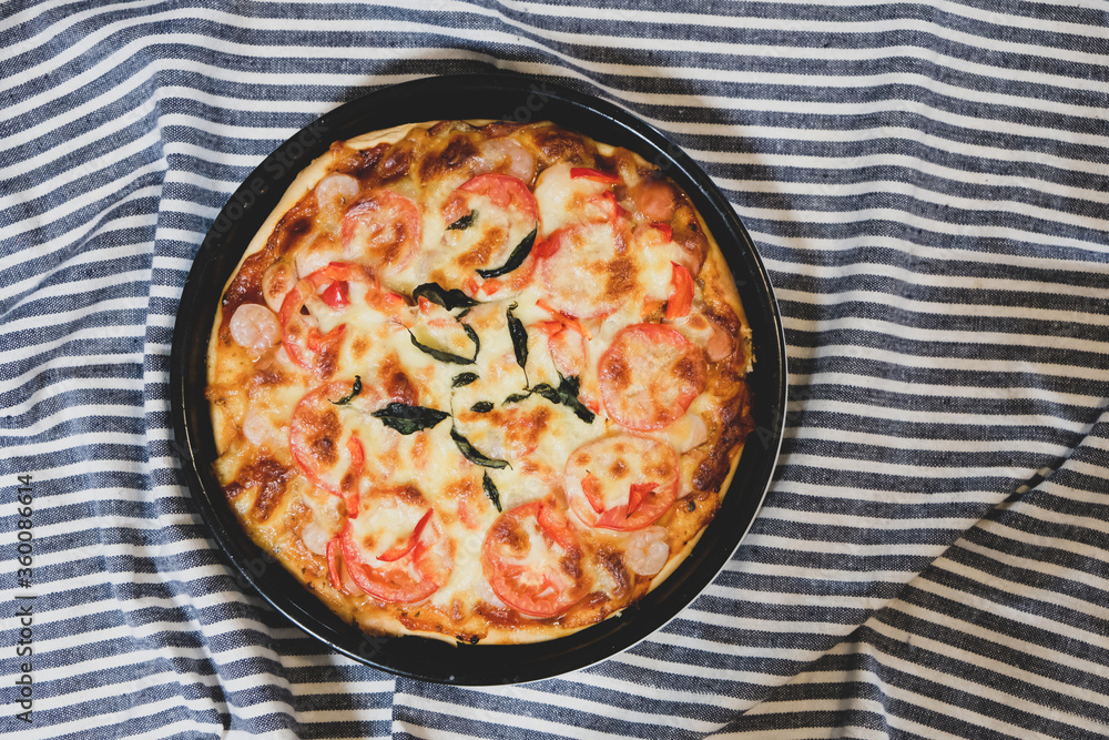 Pizza placed on the table with linen