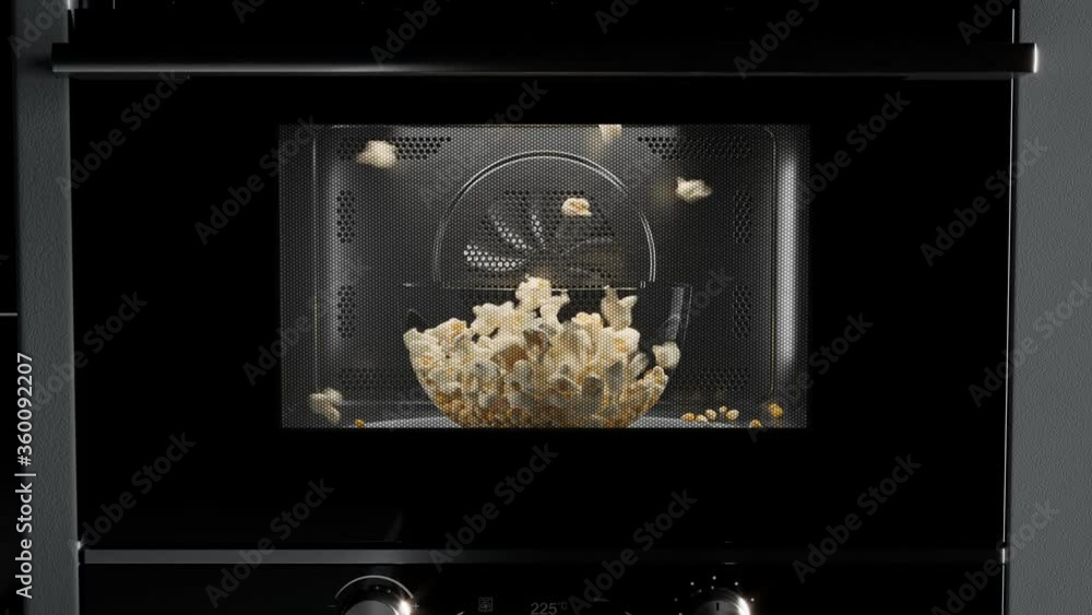 Popcorn preparation. Corn seeds popping up from glass bowl at the