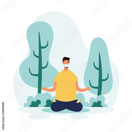 man wearign medical mask practicing yoga in park scene