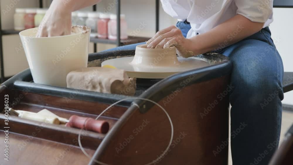 Hands of a potter, creating an earthen jar on the circle Hands of a potter, creating an earthen jar on the circle