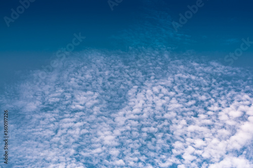 Light white cloud with blue sky background.