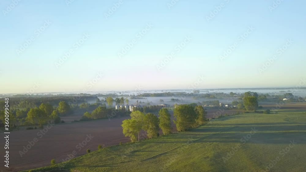 Farming fields in the morning with drone in early fog after sunrise. Farming fields in the morning with drone in early fog after sunrise.