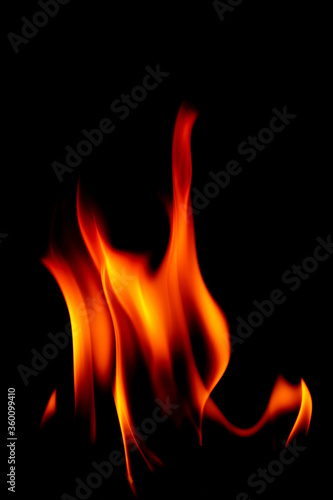 Real fire line flames isolated on black background. Mockup fire wall.