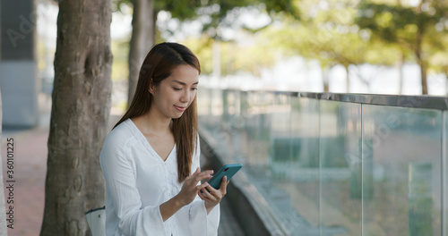 Photography Woman look at mobile phone in city