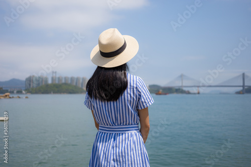 Travel woman looks at the sea