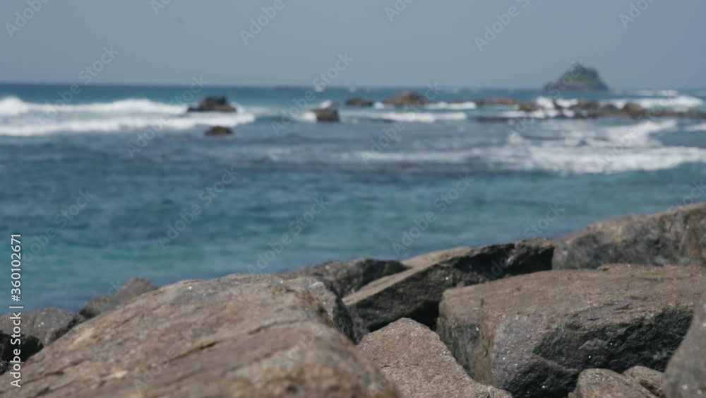Blue Ocean Waves Crashing On The Rocks And Shore In Weligama, Sri Lanka At Daytime. - wide shot Blue Ocean Waves Crashing On The Rocks And Shore In Weligama, Sri Lanka At Daytime. - wide shot