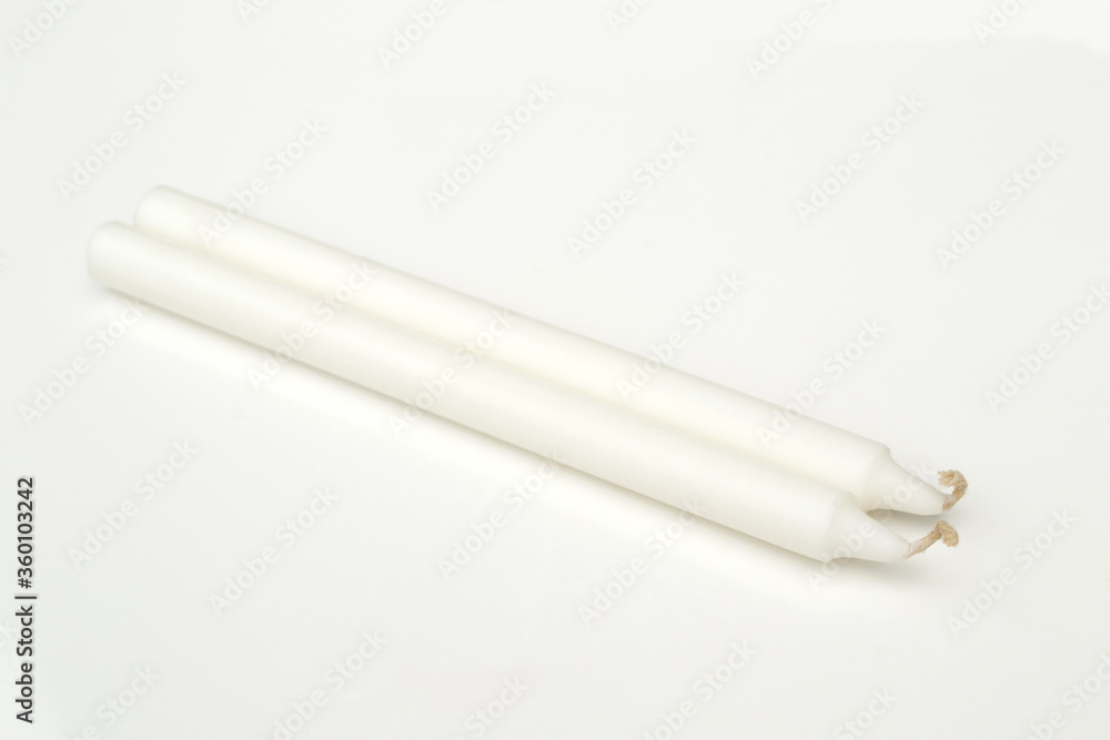 White candles isolated on a white background. White candles isolated on a white background.