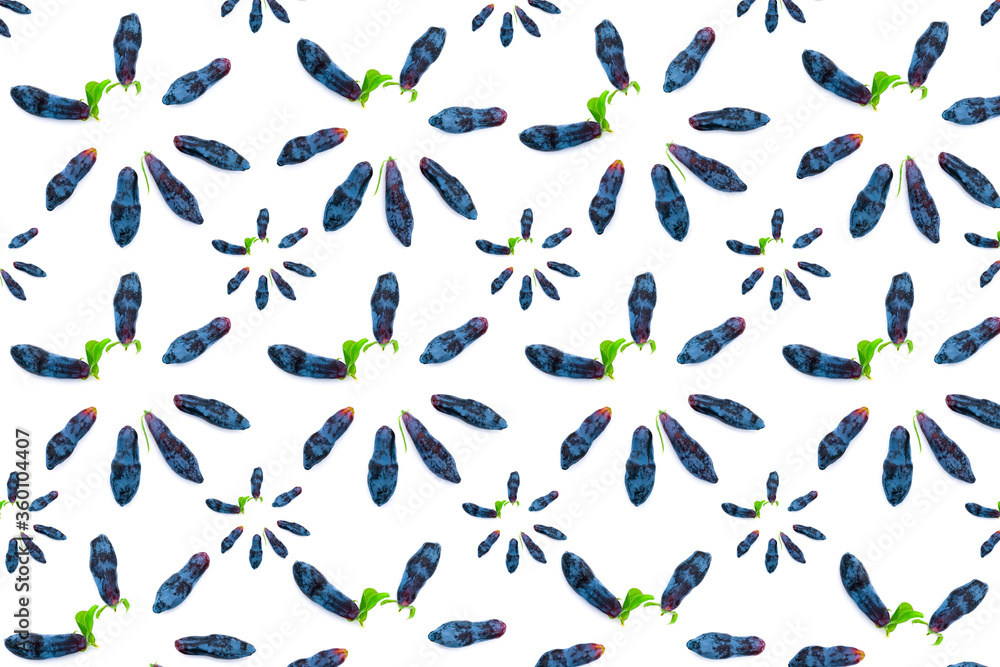 Pattern food from early blue honeysuckle berries (lat. Lonicera coerulea) on a white background Pattern food from early blue honeysuckle berries (lat. Lonicera coerulea) on a white background