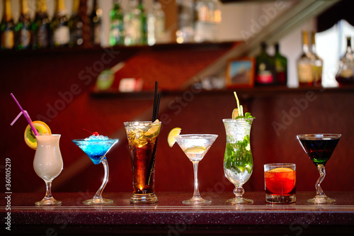 Set of classic alcohol cocktails on bar background