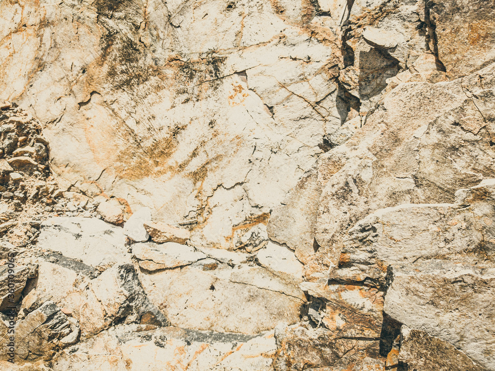 Natural background. Closeup edged shabby cliff cracks. Gray-brown stone rock texture of mountains. Vintage and faded matt style colour in tinted photo. Concept of geolog, mountaineering or hard work Natural background. Closeup edged shabby cliff cracks. Gray-brown stone rock texture of mountains. Vintage and faded matt style colour in tinted photo. Concept of geolog, mountaineering or hard work
