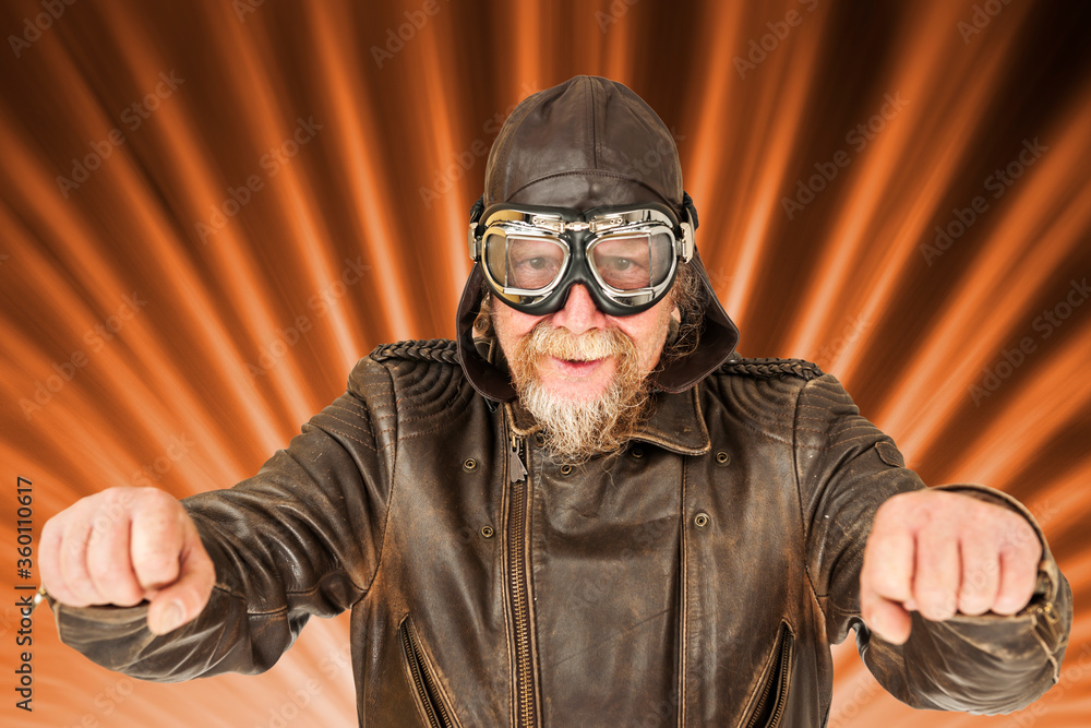 Fun motorcyclist posing on radiating background Fun motorcyclist posing on radiating background