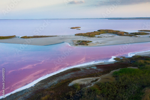 Shooting from air to pink salt lake with amazing patterns on the water